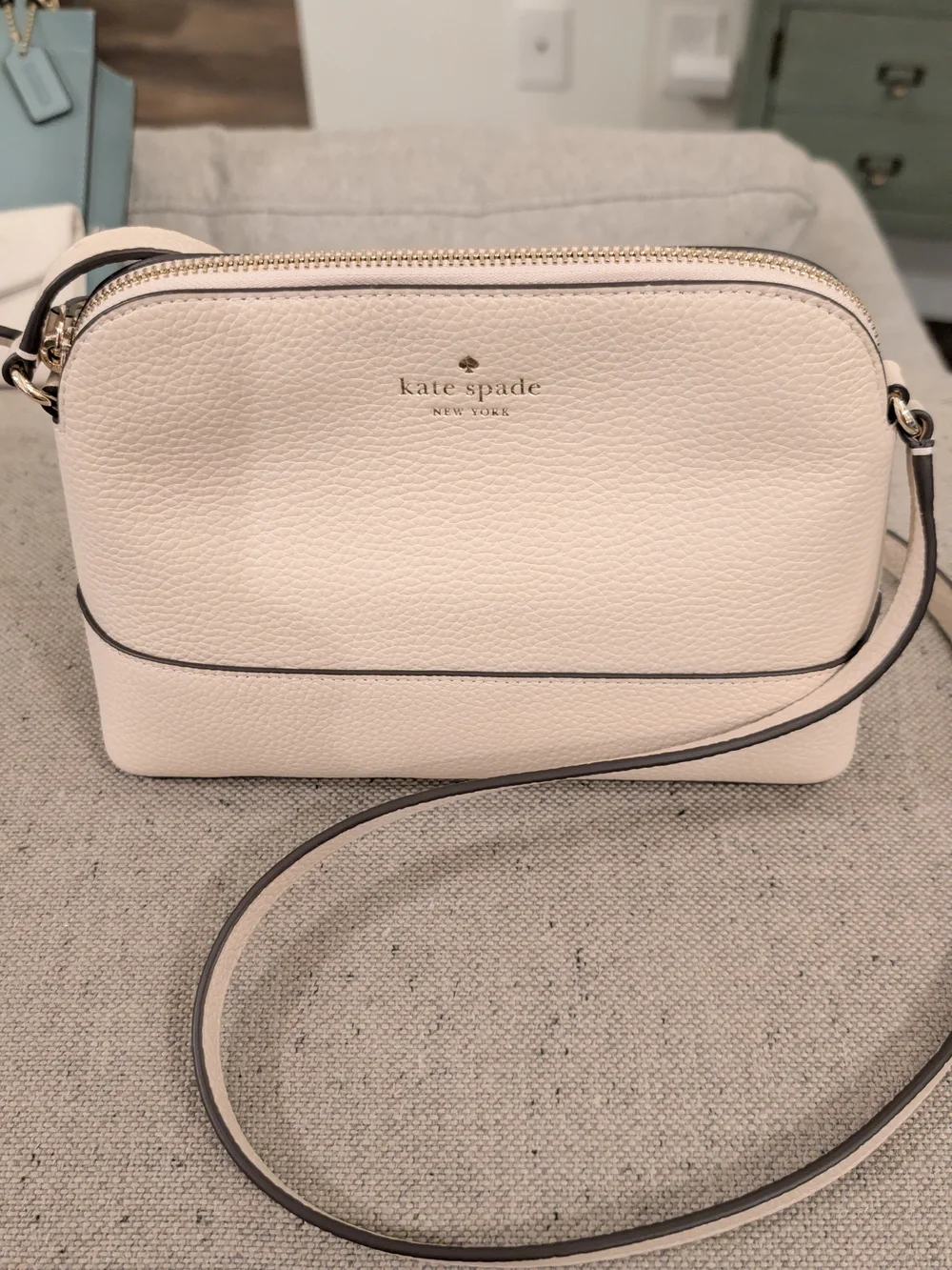 kate spade cream pebbled leather crossbody with gold logo